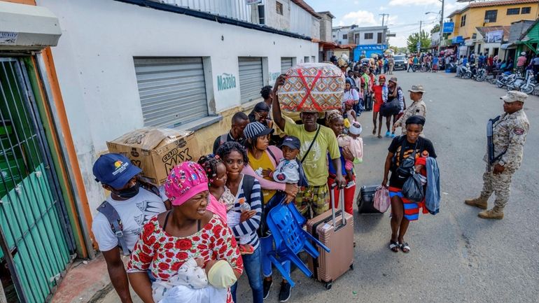 People wait on the closed border bridge to cross back...