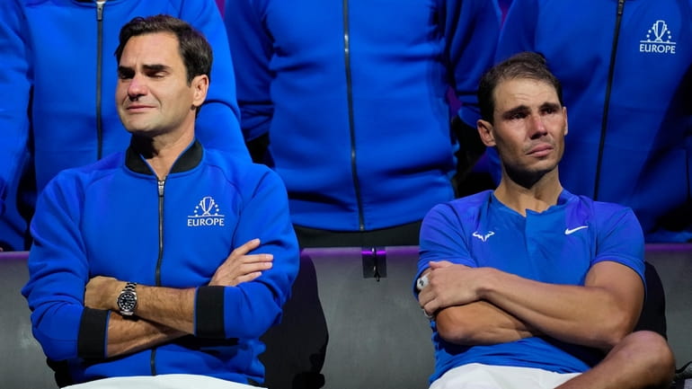 An emotional Roger Federer, left, of Team Europe sits alongside...