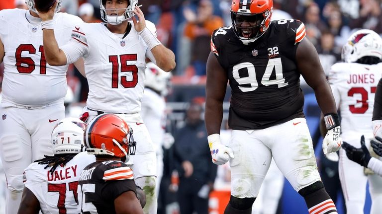 Cleveland Browns defensive tackle Dalvin Tomlinson (94) reacts after making...