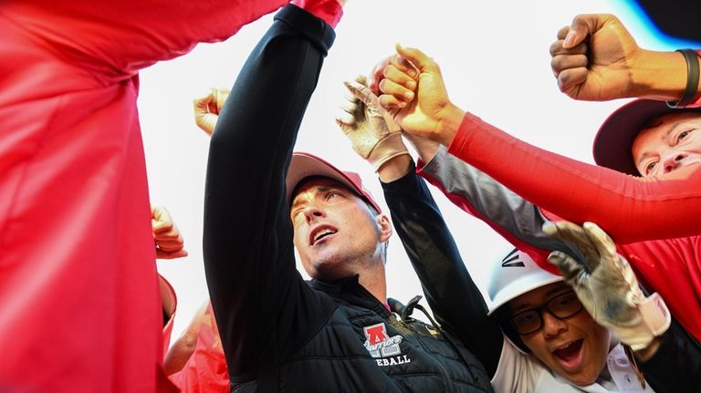 Amityville head coach Jack Zider cheers with his team after...