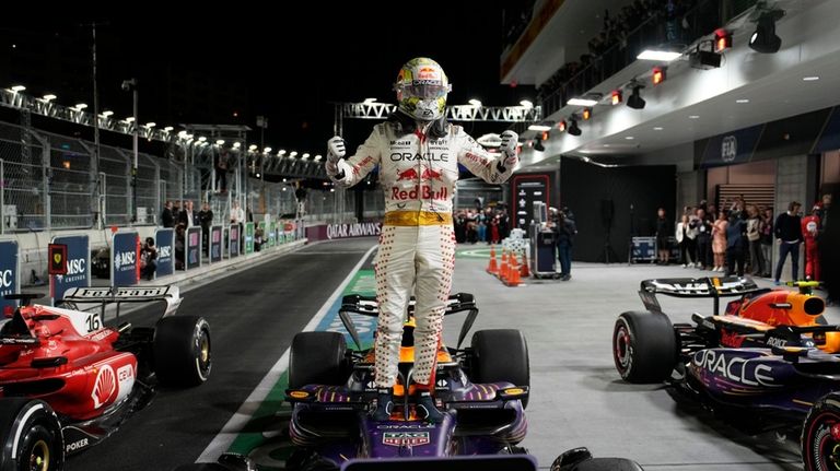 Red Bull driver Max Verstappen, of the Netherlands, stands on...