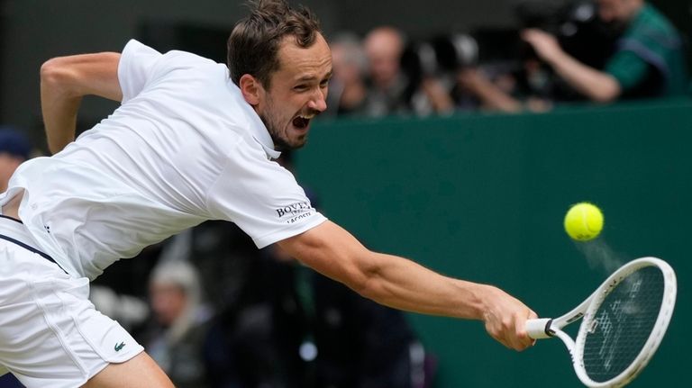 Daniil Medvedev of Russia plays a backhand return to Carlos...