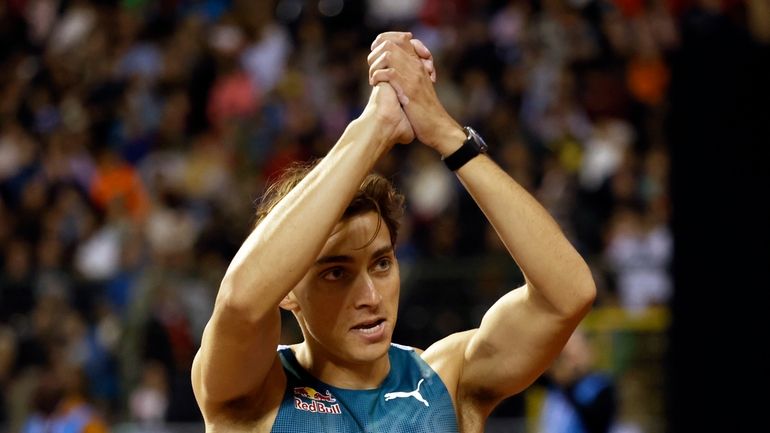 Armand Duplantis, of Sweden, celebrates after winning the men's pole...