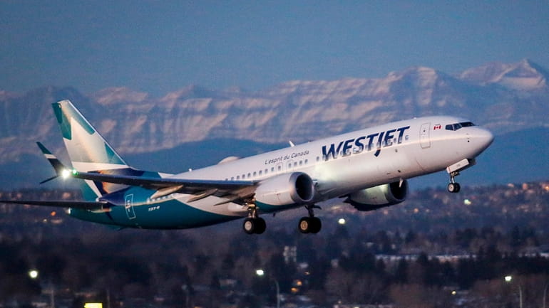 A westJet airplane takes off in Calgary, Alta., Jan. 21,...