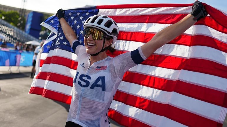 Kristen Faulkner, of the United States, celebrates winning the women's...