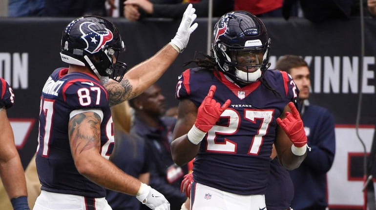 Houston Texans running back D'Onta Foreman celebrates with teammates after...
