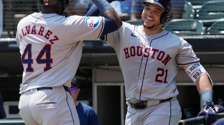 Houston Astros' Yordan Alvarez, left, celebrates with Yainer Diaz after...