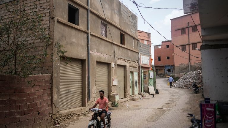 A man drives past a building which was affected by...