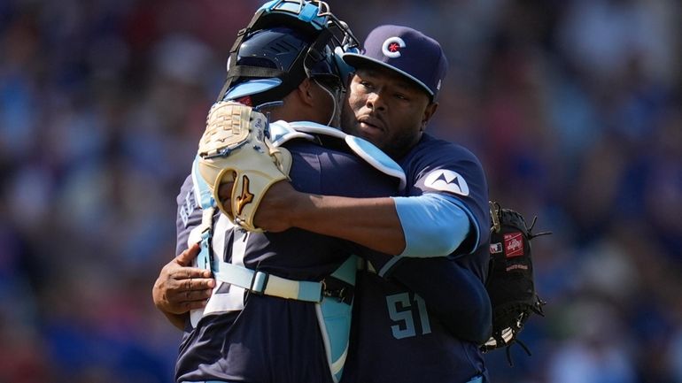 Chicago Cubs catcher Christian Bethancourt, left, and pitcher Héctor Neris,...