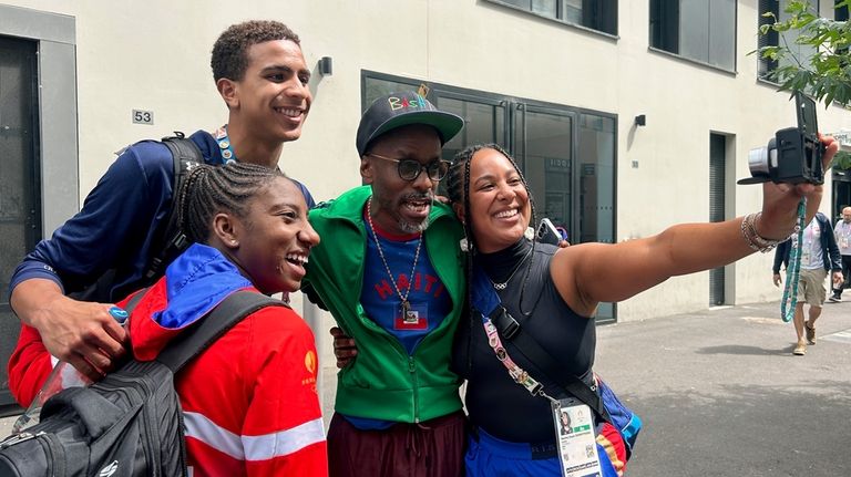 Haitian-Canadian musician Jowee Omicil takes a photo with Haiti’s team...