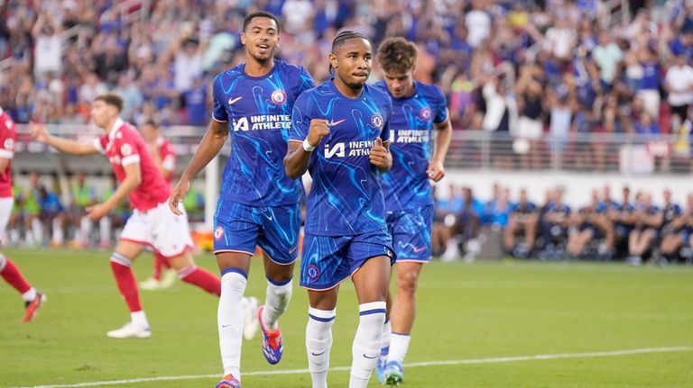 Chelsea forward Christopher Nkunku, center, celebrates after scoring a goal...