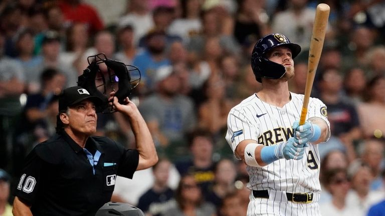 Milwaukee Brewers' Jake Bauers, right, watches his two-run home run...