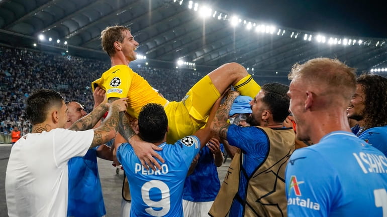 Lazio's goalkeeper Ivan Provedel celebrates with his teammates at the...