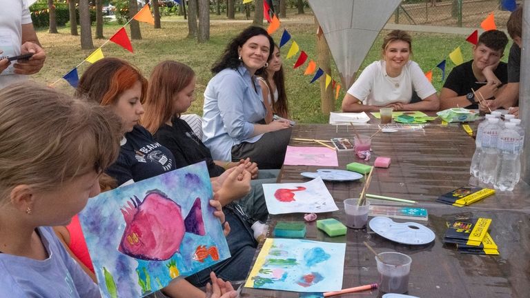 First lady Olena Zelenska talks with children during her visit...