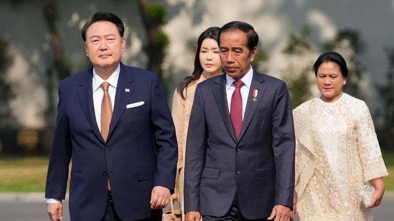 South Korean President Yoon Suk Yeol, left, and his wife...