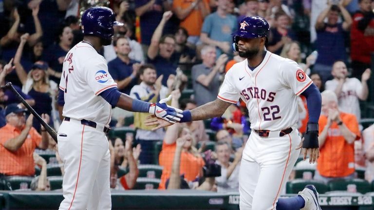 Houston Astro' Yordan Alvarez and pinch runner Jason Heyward (22)...