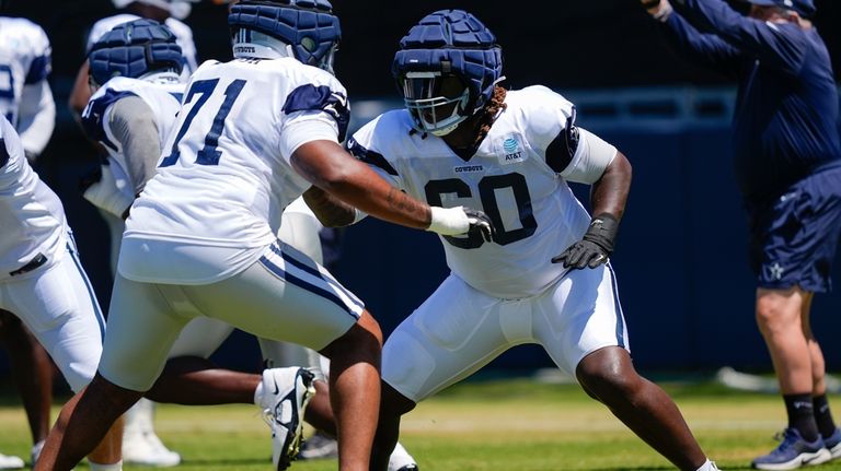 Dallas Cowboys offensive tackle Tyler Guyton, right, and guard Chuma...