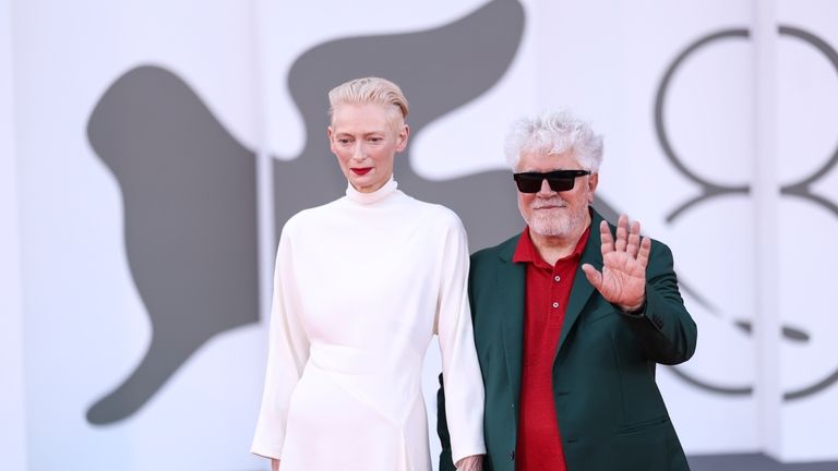 Tilda Swinton, left, and Pedro Almodovar pose for photographers upon...