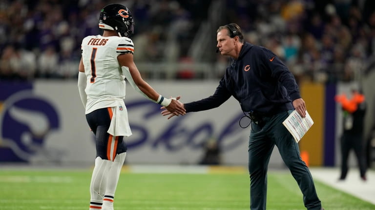 Chicago Bears head coach Matt Eberflus greets quarterback Justin Fields...