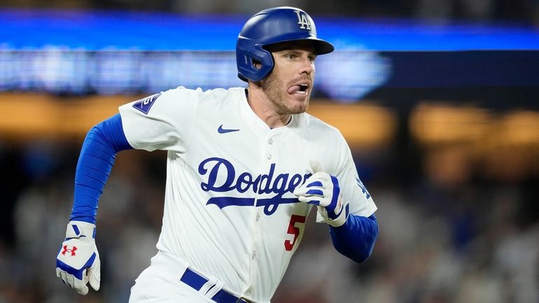 Los Angeles Dodgers' Freddie Freeman heads to first after hitting...