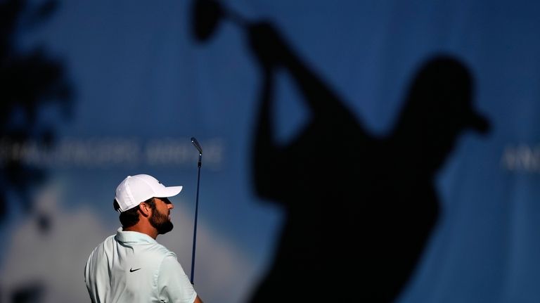 Scottie Scheffler hits on the driving range prior to the...