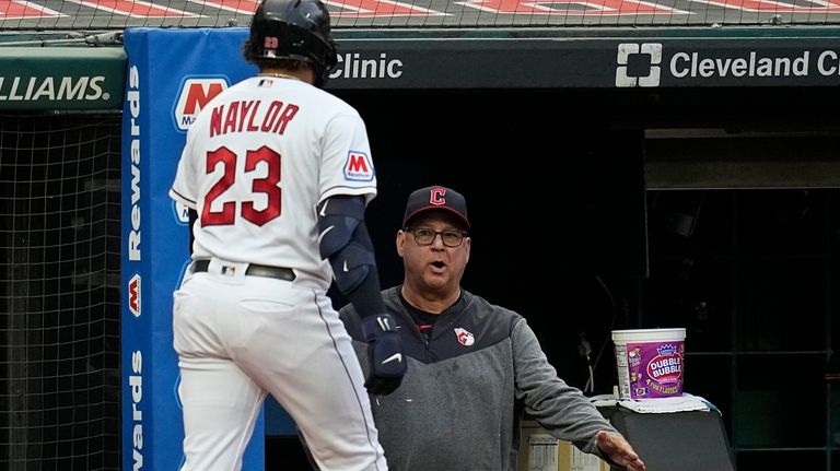 Cleveland Guardians manager Terry Francona, right, greets Bo Naylor (23),...