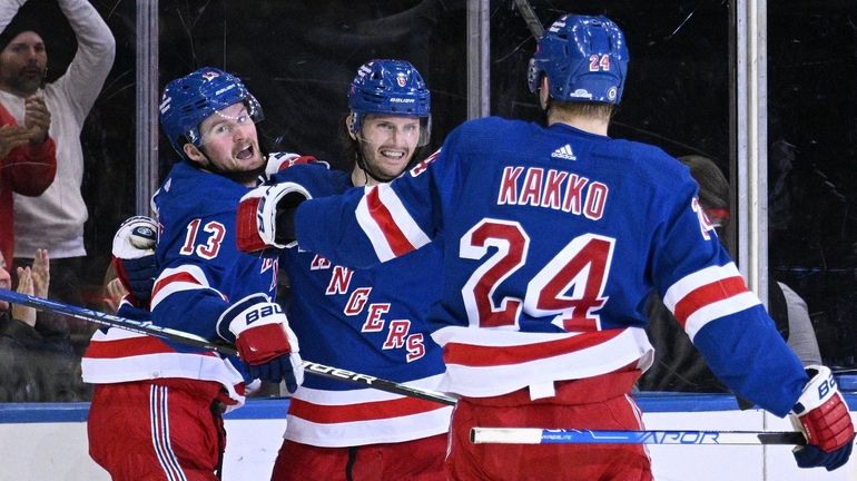 Rangers left wing Alexis Lafrenière celebrates his goal with defenseman...