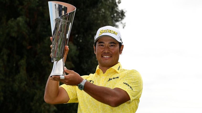 Hideki Matsuyama, of Japan, holds the the Genesis Invitational trophy...