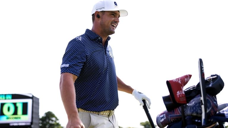 Captain Bryson DeChambeau, of Crushers GC, looks on from the...