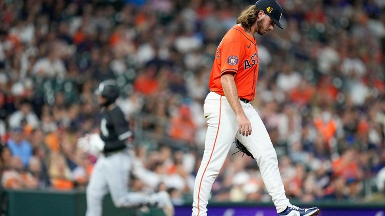 Houston Astros starting pitcher Spencer Arrighetti, right, walks to the...