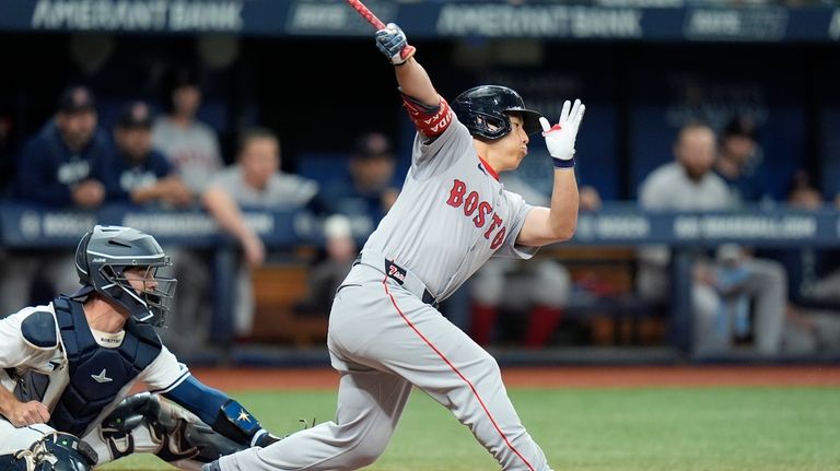 Boston Red Sox's Masataka Yoshida, of Japan, strikes out against...