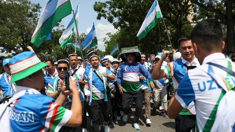 Uzbekistan supporters react as they gather ahead of the men's...