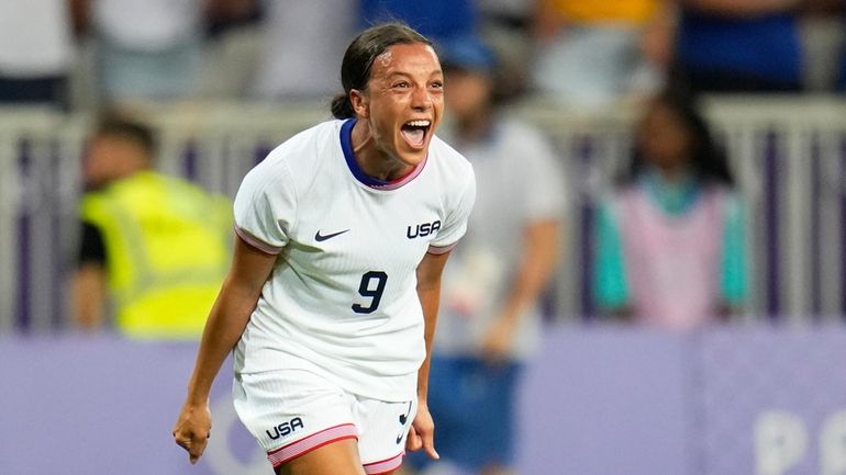 United States' Mallory Swanson reacts after teammate Trinity Rodman scored...