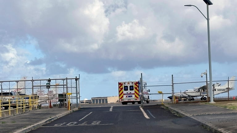 An ambulance enters Lihue Airport on the island of Kauai,...