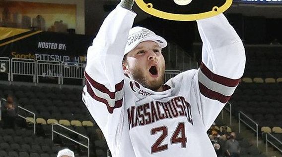 Zac Jones of the Massachusetts Minutemen celebrates with the trophy...