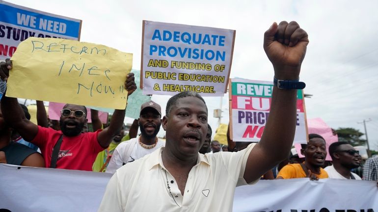 People protest against the economic hardship on the street in...