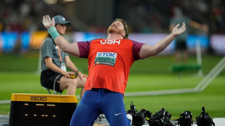 Ryan Crouser, of the United States, reacts after his final...