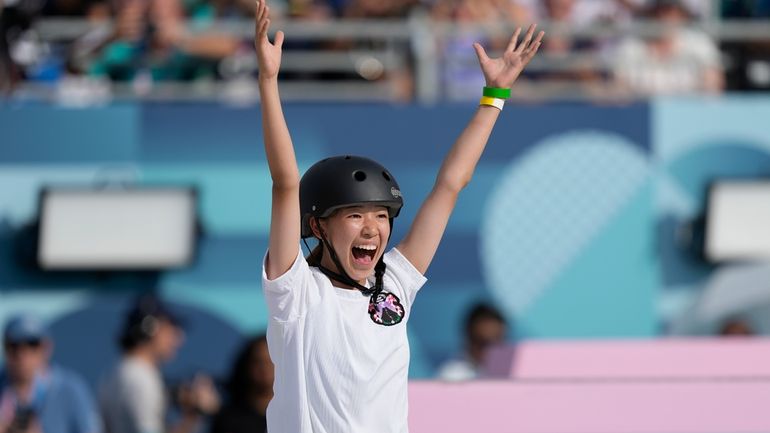 Coco Yoshizawa, of Japan, celebrates after winning the gold medal...