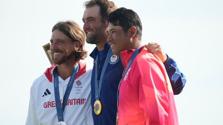 Gold medalist Scottie Scheffler, of the United States, centre, with...