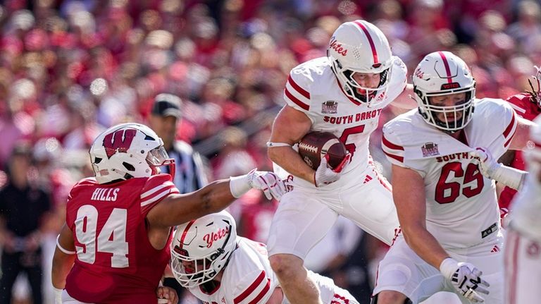 South Dakota running back Travis Theis (5) runs against Wisconsin...