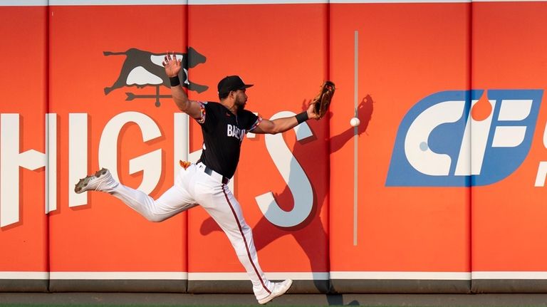 Baltimore Orioles right fielder Anthony Santander is unable to catch...