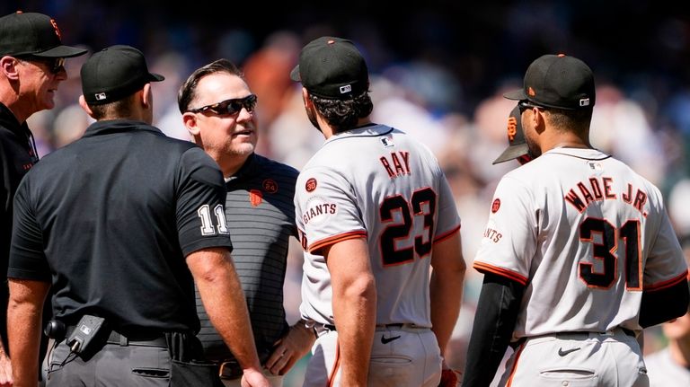 San Francisco Giants starting pitcher Robbie Ray (23) is checked...