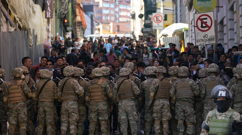 Military police block entry to Plaza Murillo in La Paz,...