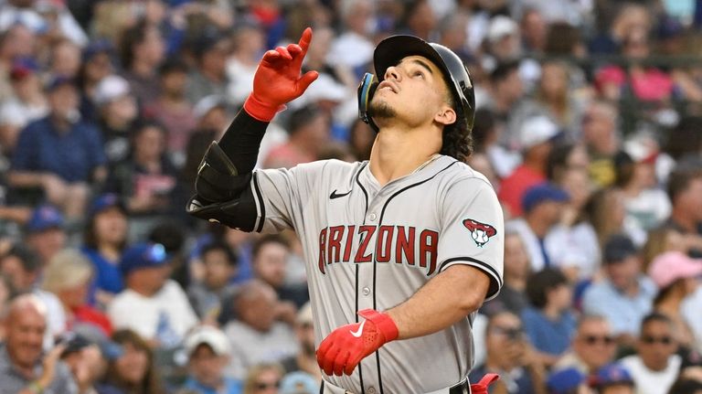 Arizona Diamondbacks outfielder Alek Thomas gestures after hitting a home...