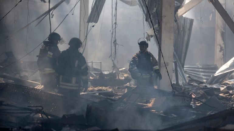 Emergency workers search for victims after a Russian missile hit...