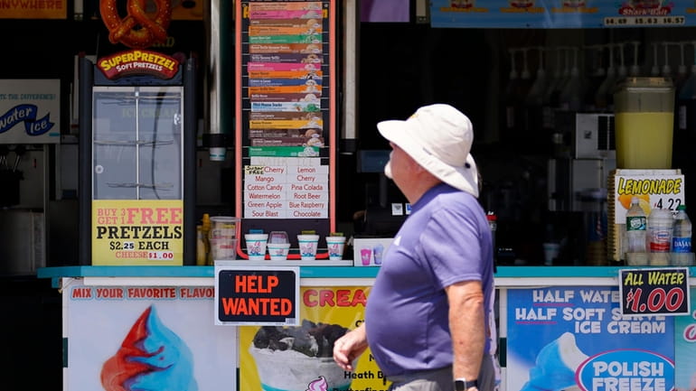 A person walks past an ice cream stand on the...