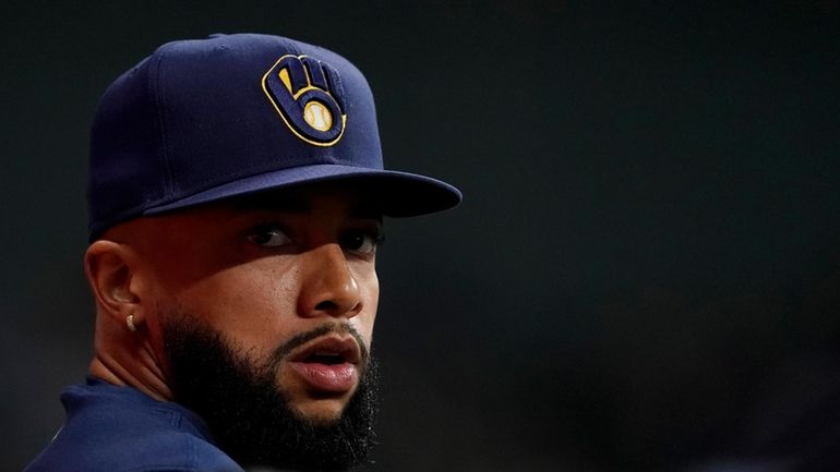 Milwaukee Brewers' Devin Williams watches from the dugout during the...