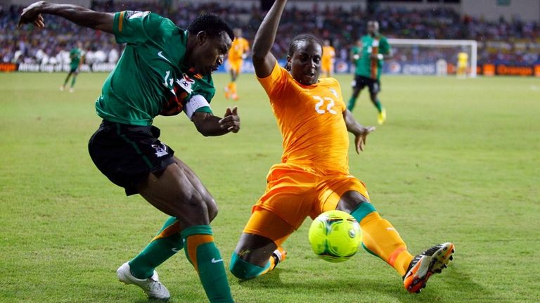 Ivory Coast's Souleymane Bamba, right, is challenged by Zambia's Christopher...