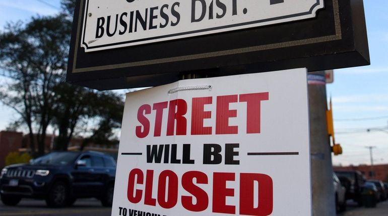 Signs are posted on Main Street in Patchogue in preparation...