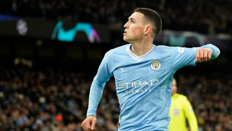 Manchester City's Phil Foden celebrates after scoring his side's second...